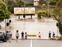 Flood waters and observers gather on Milton Road, one of deepest of the flooded areas.