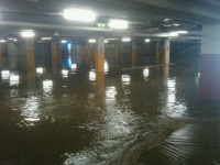 Water continues to build in the New Farm Village car park, where Coles is situated just above.