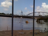 The river sweeps up construction equipment at South Bank.